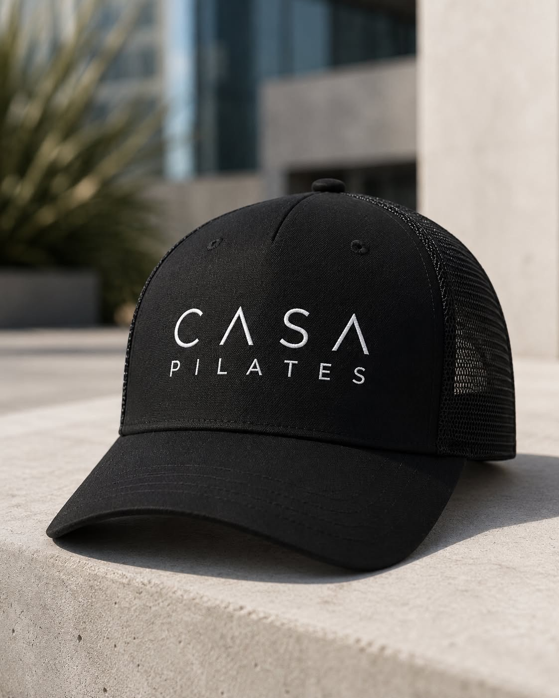 Casa Pilates black trucker hat with embroidered logo